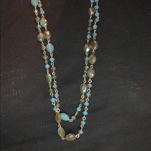 2 matching blue and gold necklaces